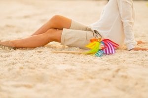 person on beach with windmill