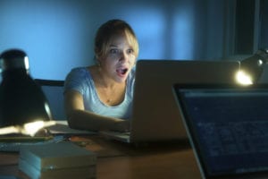 woman shocked at computer screen