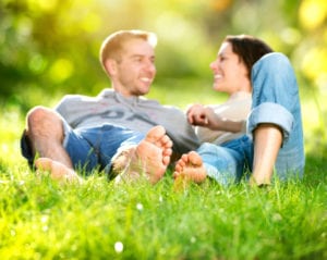 happy couple laying in grass