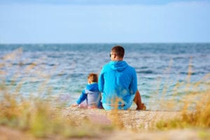 man and son on beach