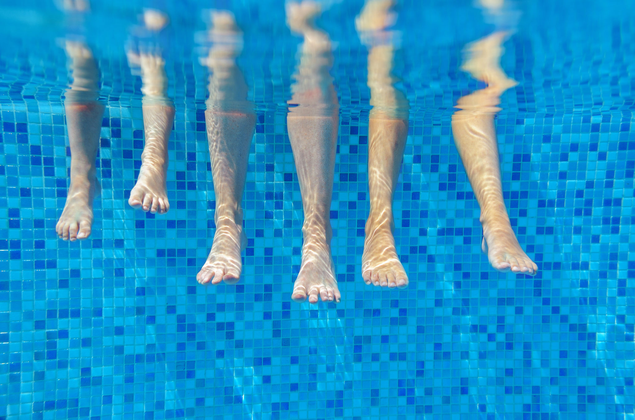 family legs underwater