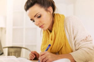 woman writing it Down on Paper