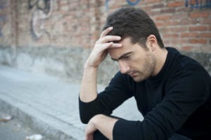 man holding top of head