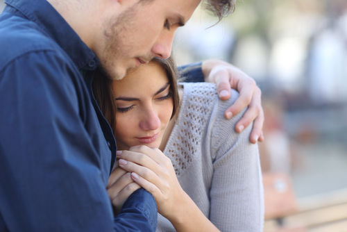 man hugging woman