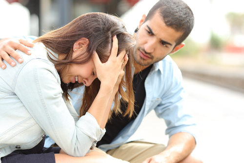 man comforting sad girl