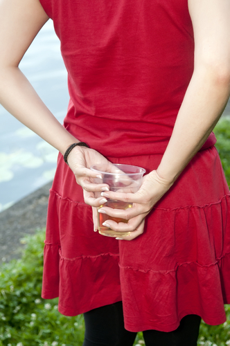 woman hiding her drink