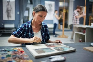 woman painting at art studio