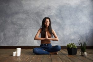 woman doing yoga in room