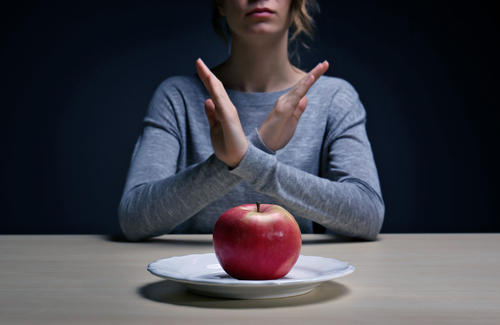 woman saying no to apple