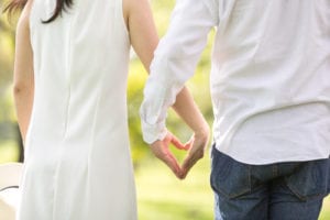 couple making heart shape with hands