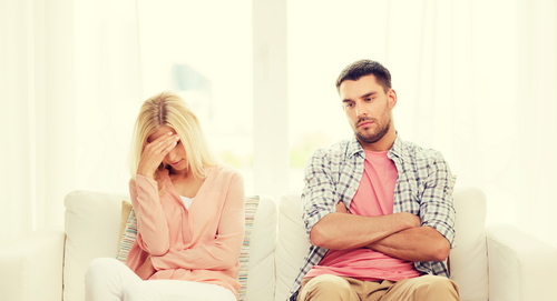 couple unhappy with each other sitting down