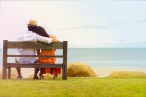 couple on bench facing water