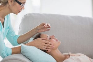 woman getting Acupuncture on face