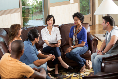 group of people talking on couch