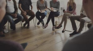 people's legs in group meeting