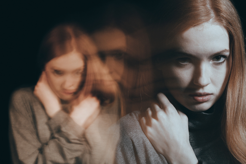 woman with blurred images of self behind her