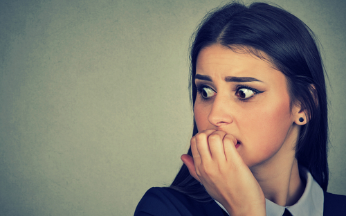 woman anxiously biting nails