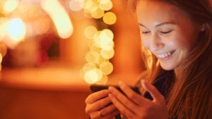 Woman smiling into phone