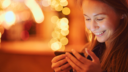 Woman smiling into phone