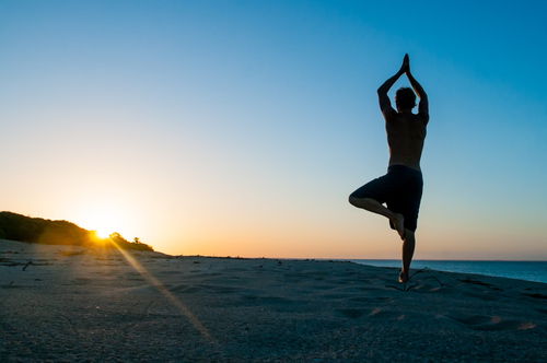 man doing yoga tree pose