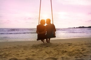 couple on swing on beach