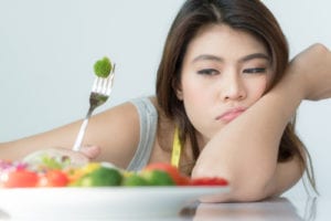 sad woman looking at food