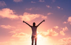 woman with thumbs up to sky