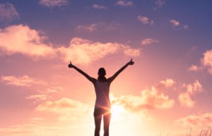 woman with thumbs up to sky