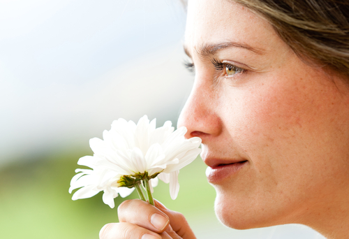 woman smelling flower