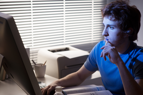 man looking at computer screens