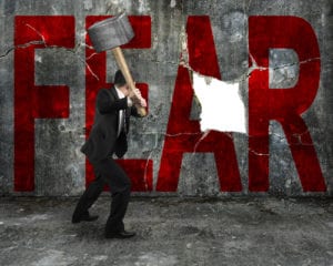 man smashing word FEAR