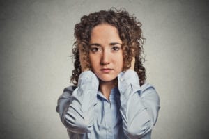 woman covering ears