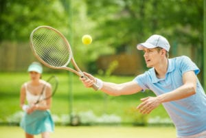 man hitting tennis ball