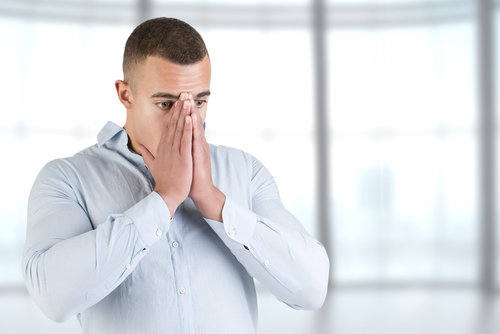 man breathing into hands