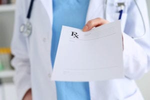 doctor handing over prescription