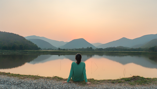 woman seated near edge of water