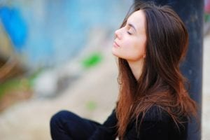 woman breathing with eyes closed