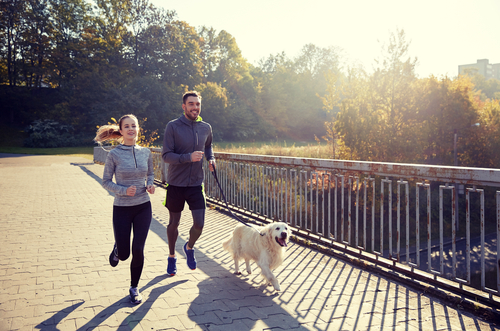 couple and dog running