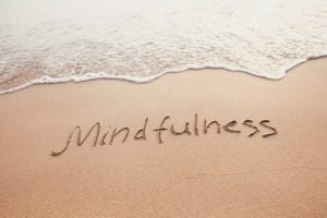 mindfulness written on sand