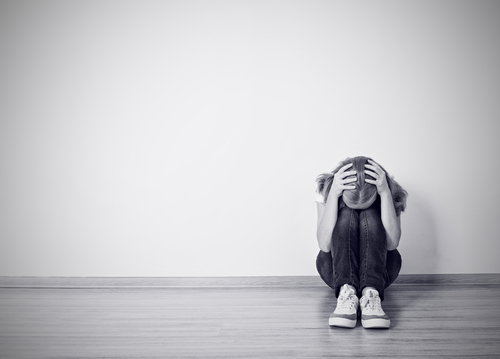 black and white image of girl covering head