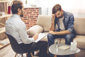 guy looking distressed in therapy