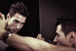 man looking self in mirror