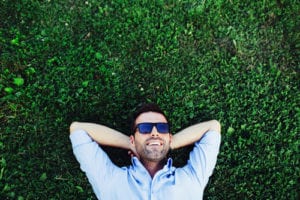 relaxed man lying in grass