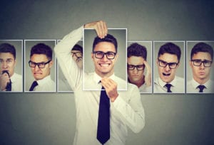 man holding multiple photos of self