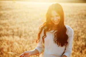 woman smiling in sunny field