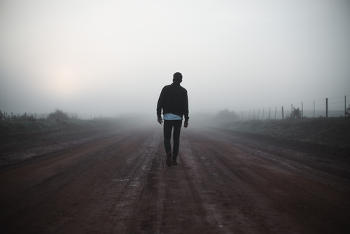 man walking in fog