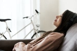 woman-couch-listening-headphones