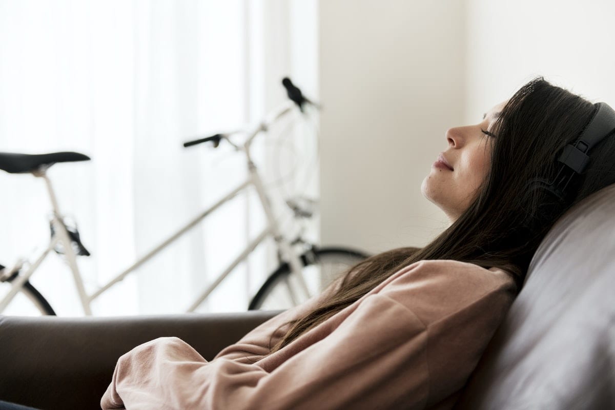 woman-couch-listening-headphones