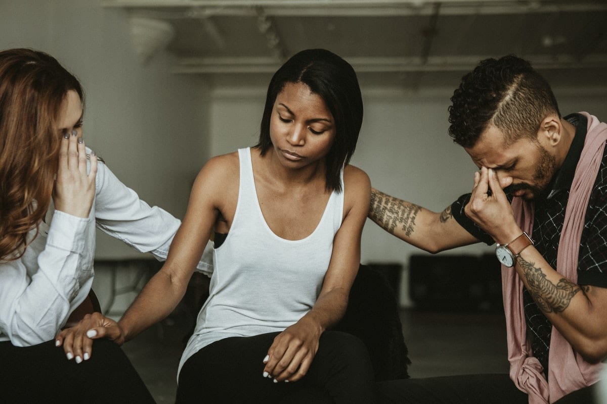 woman being consoled in therapy or intervention