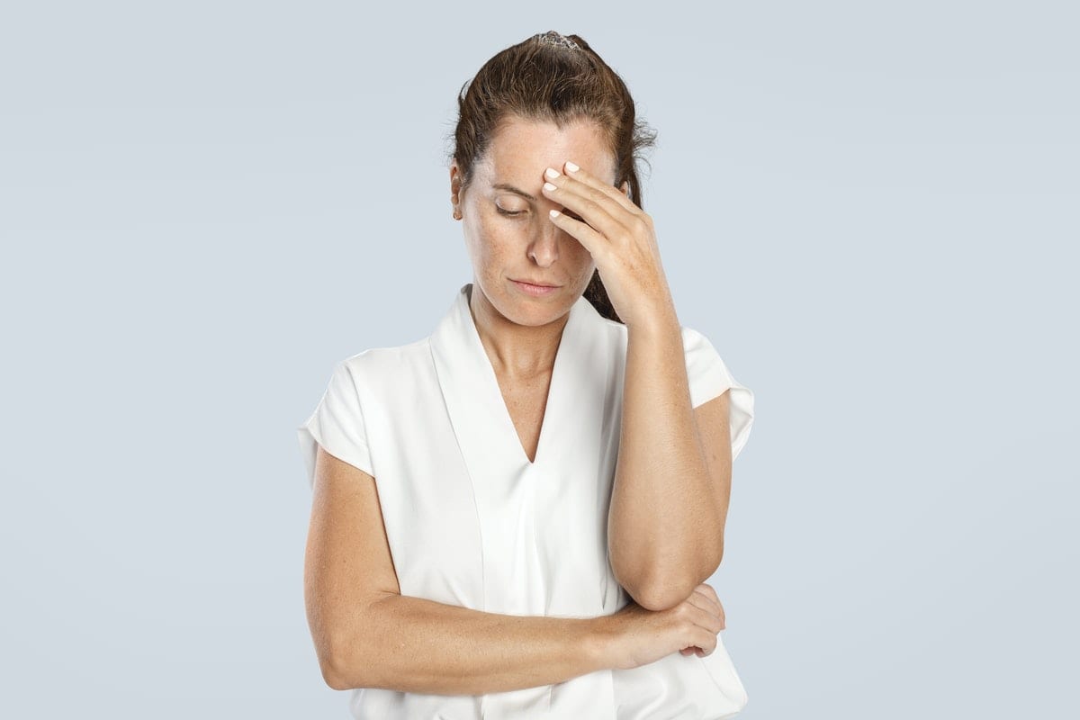 Stressed woman mockup psd touching her forehead